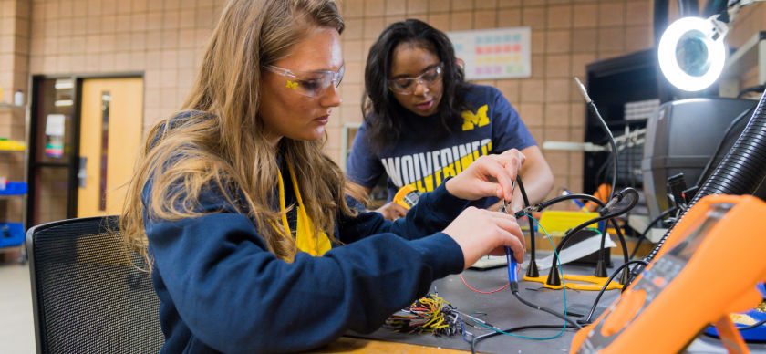 Two students work on an engineering project.