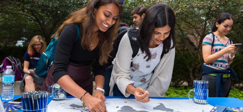 Two students interacting with a map during an event