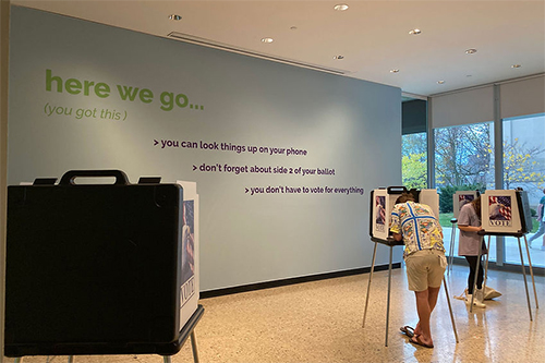 Voters using voting booths at the U-M Museum of Art